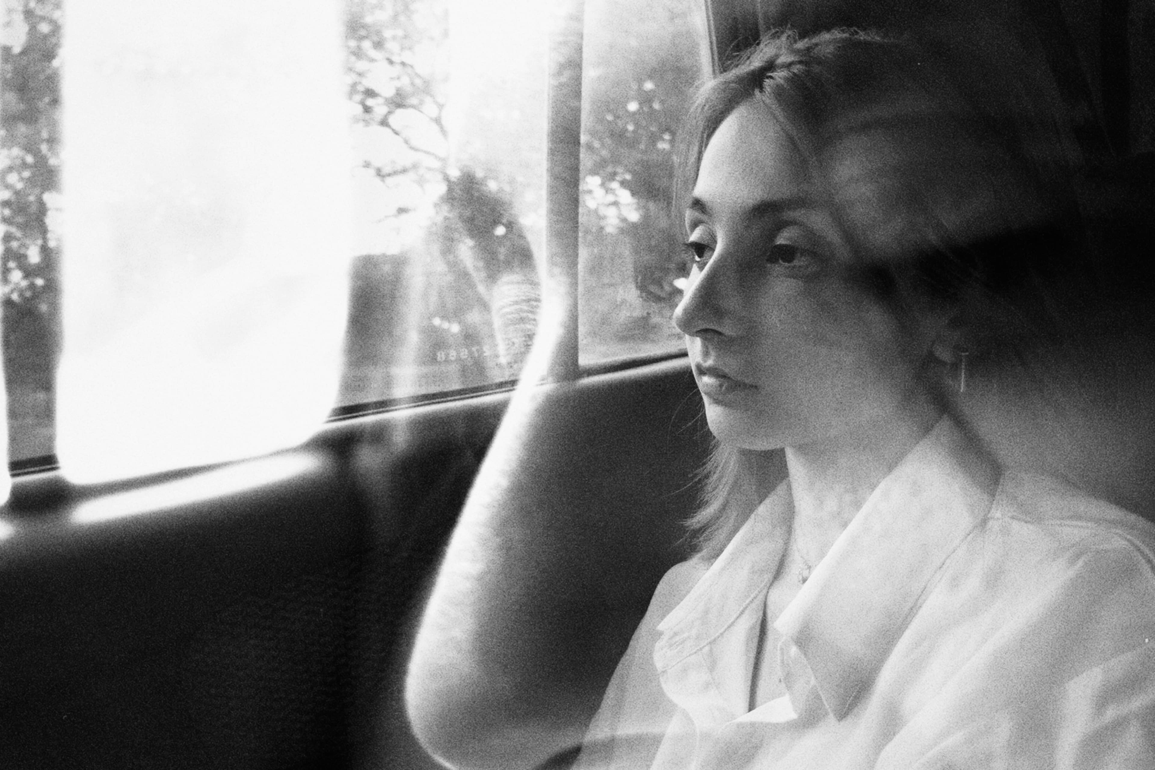 Woman looking out a window — anxiety vs depression and how to tell the difference