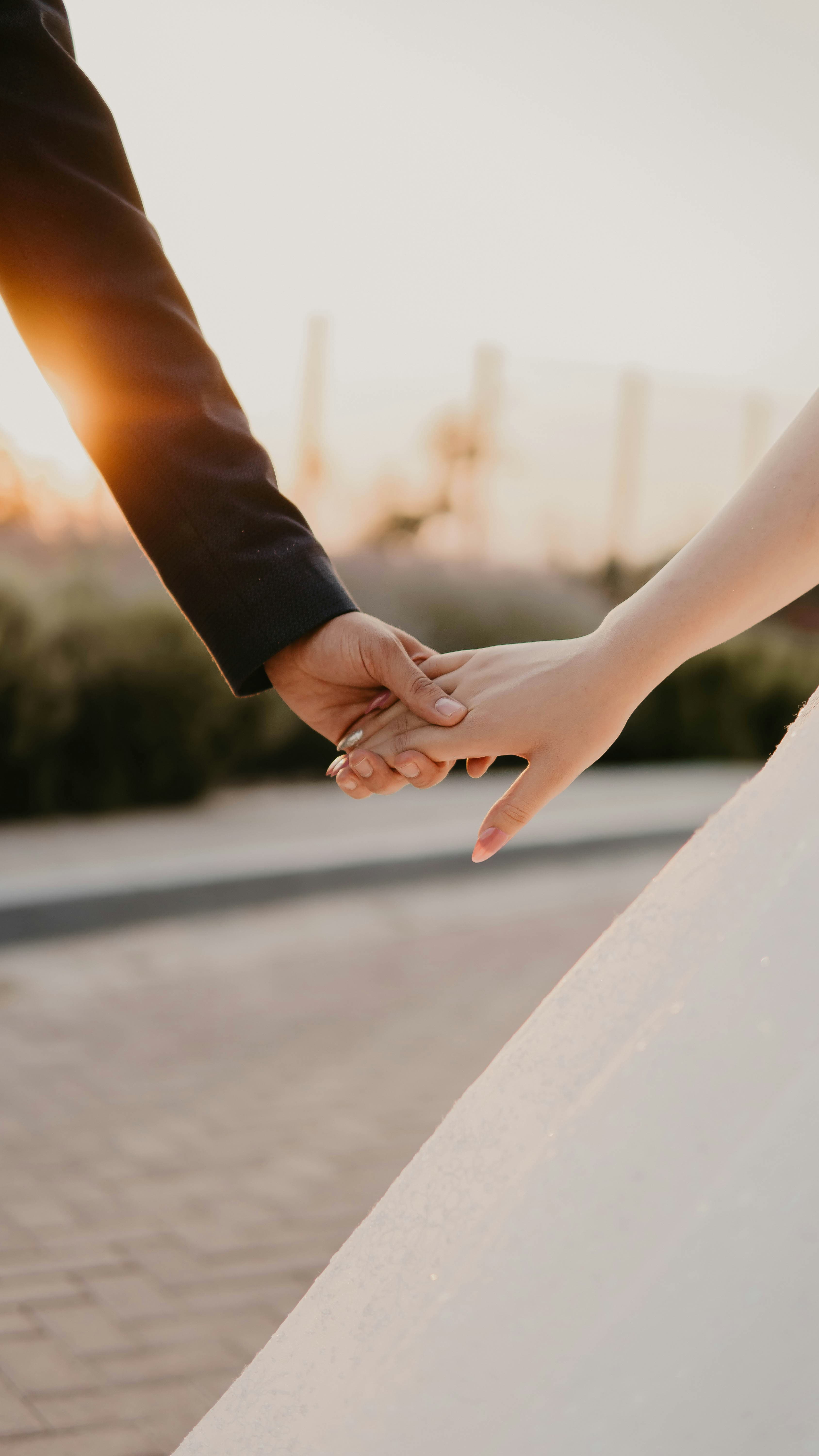 Married couple holding hands — couples therapy when one partner is hesitant